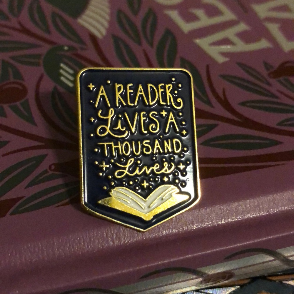 “A Reader Lives A Thousand Lives” Enamel Pin